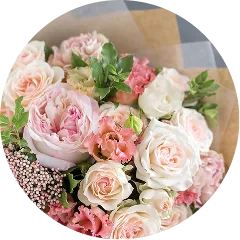 淡いピンクと白のバラをメインにしたボリュームのある花束。