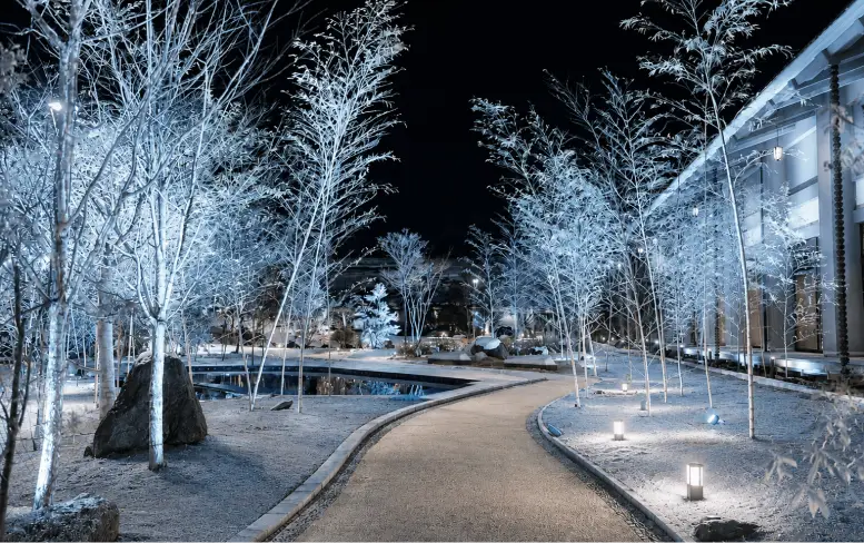 雪景色を思わせる白と青の冷たい光で照らされた冬の庭園